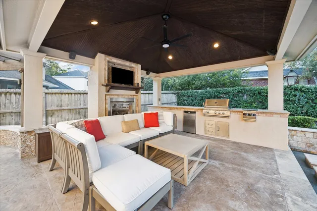 a living room with patio furniture and a flat screen tv