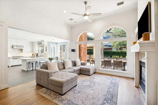 a living room with furniture a fireplace and a flat screen tv