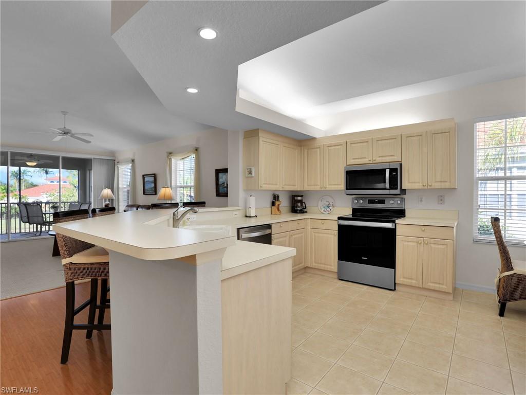 23731 Eddystone Road, Unit 6204 Estero, FL 34135 - Photo 13 of 30 a kitchen with stainless steel appliances kitchen island granite countertop a sink and cabinets