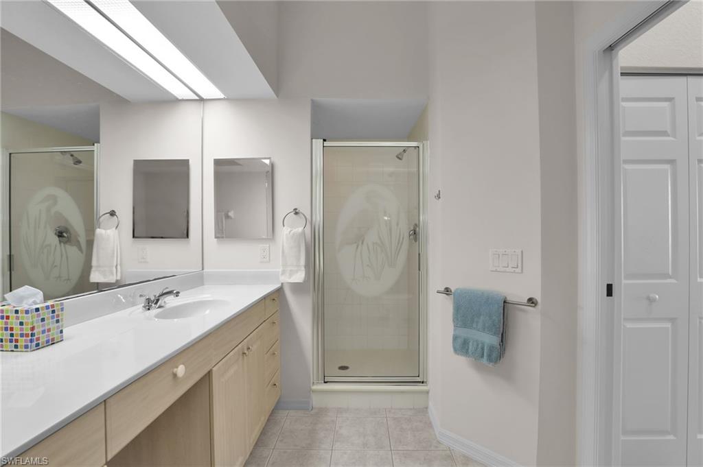 23731 Eddystone Road, Unit 6204 Estero, FL 34135 - Photo 23 of 30 a spacious bathroom with a shower sink and mirror