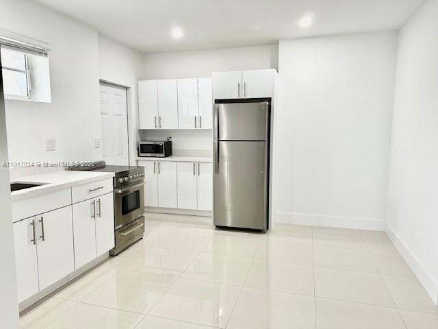3801 Ponce De Leon, Unit EFFICIENCY Coral Gables, FL 33134 - Photo 7 of 16 a kitchen with white cabinets and white appliances