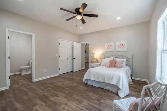 a bedroom with a bed and a ceiling fan