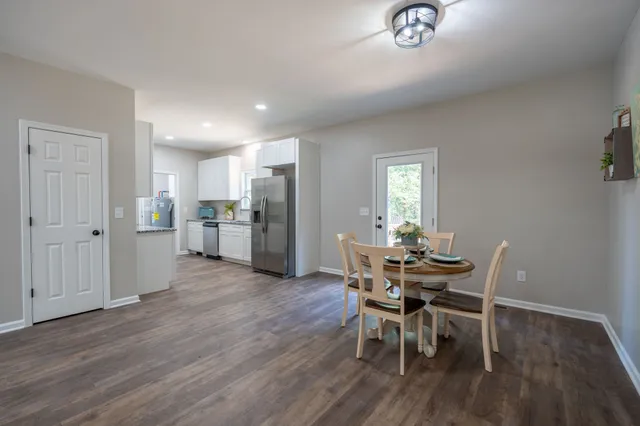 a view of a dining room with furniture and wooden floor