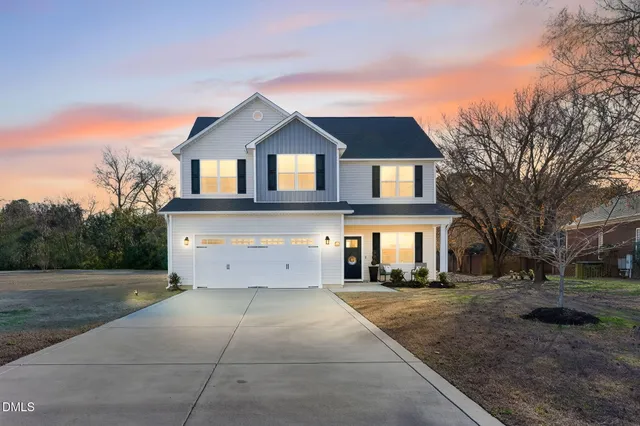 a front view of a house with a yard and garage