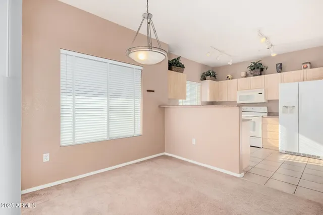 a kitchen with stainless steel appliances a refrigerator and a stove top oven