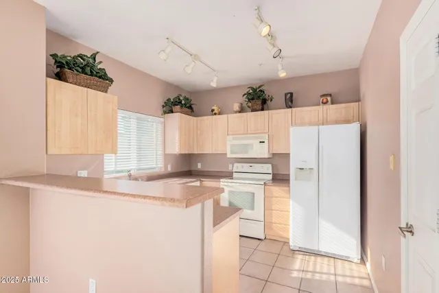 a kitchen with kitchen island a stove a refrigerator and a sink