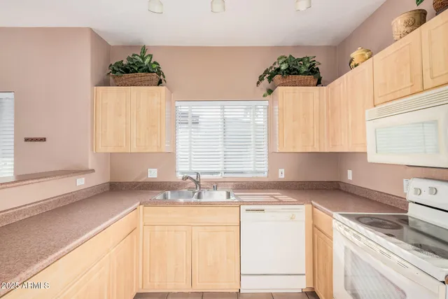 a kitchen with a sink stove and cabinets