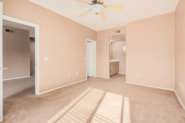 a view of an empty room with a ceiling fan
