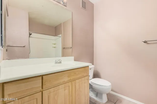 a bathroom with a sink a toilet and mirror