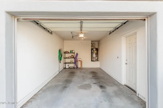 a view of a hallway with a ceiling fan and a window