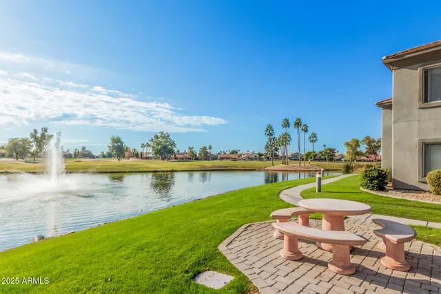 a view of a lake with a table and chairs