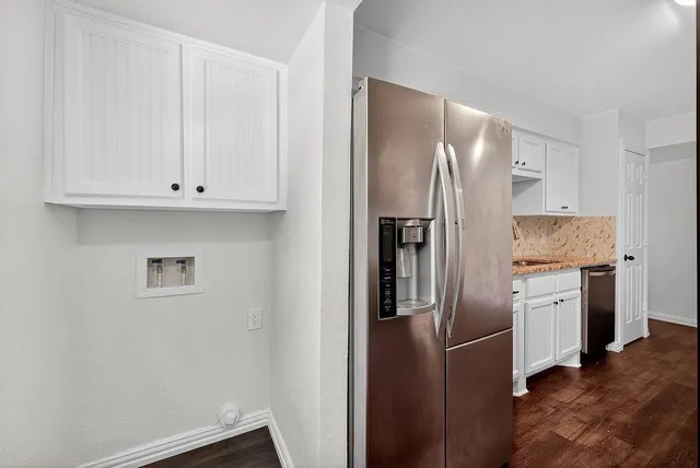 a kitchen with stainless steel appliances granite countertop a refrigerator and a stove