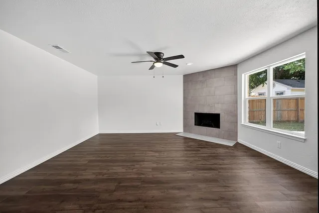 wooden floor in an empty room with a fireplace