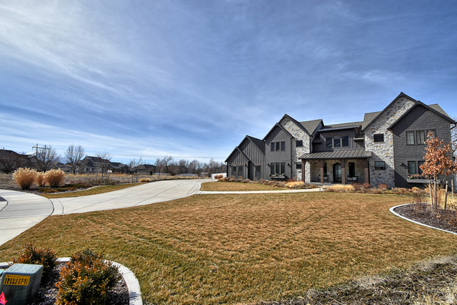 509 West 350th Street South, Unit 30 Mapleton, UT 84664 - Photo 14 of 25 View of front facade with a standing seam roof, a front yard, a porch, and stone siding