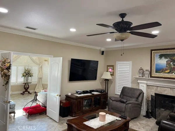 a bedroom with a bed a flat screen tv and a couch