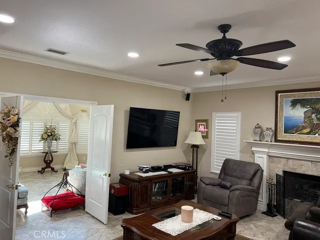 a bedroom with a bed a flat screen tv and a couch