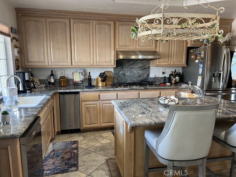 16130 Reiner Circle Riverside, CA 92504 - Photo 25 of 74 a kitchen with stainless steel appliances granite countertop a sink stove and cabinets