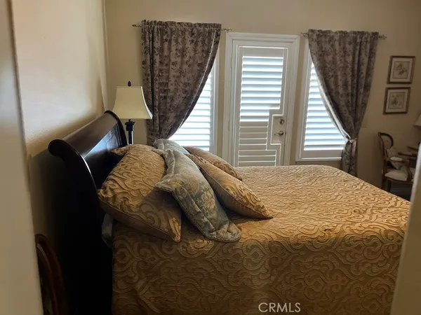 a bedroom with a bed and window