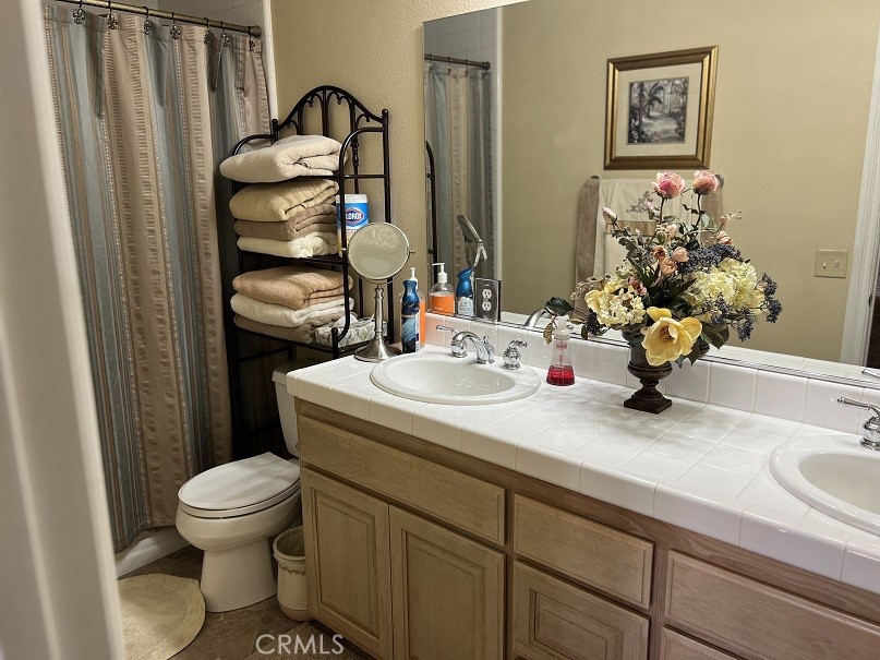 16130 Reiner Circle Riverside, CA 92504 - Photo 28 of 74 a bathroom with a sink toilet and a mirror