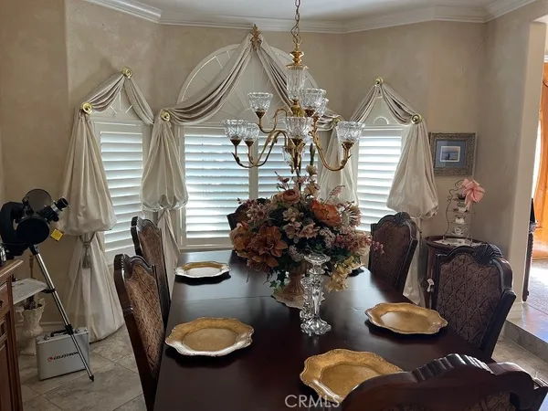 a view of a dining room with furniture and chandelier