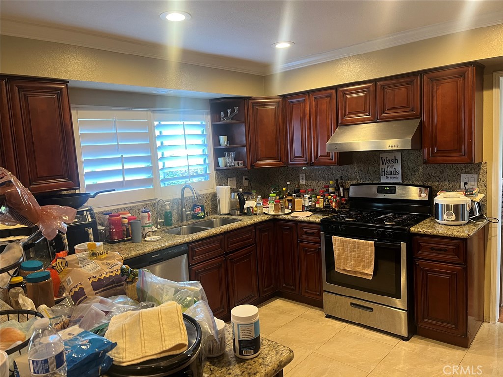 7784 Silver Buckle Road Highland, CA 92346 - Photo 3 of 11 a kitchen with a sink stove and cabinets