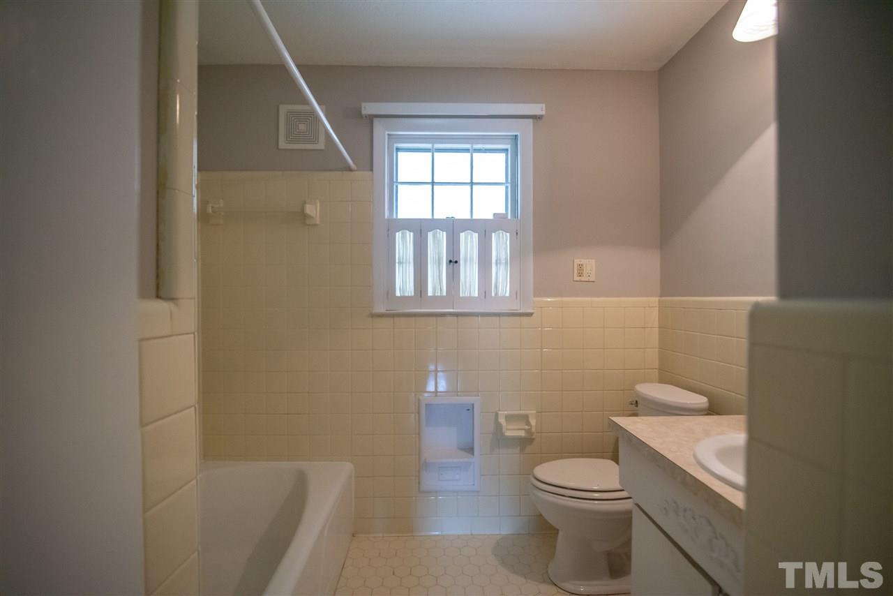 1413 Kennon Road Garner, NC 27529 - Photo 13 of 25 Convenient first floor bath featuring vanity and tub/shower combo.