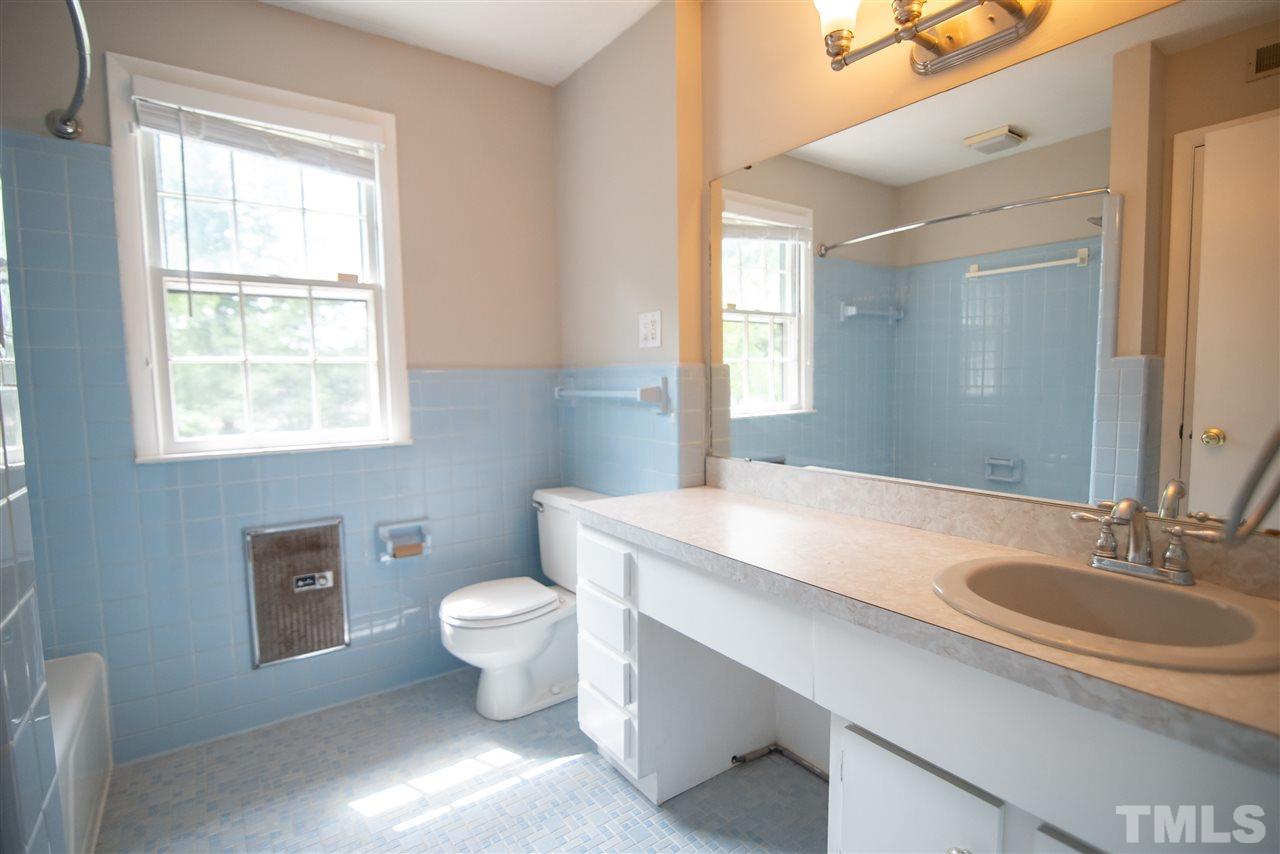 1413 Kennon Road Garner, NC 27529 - Photo 18 of 25 Second floor hall bathroom features vanity and tub/shower combo.