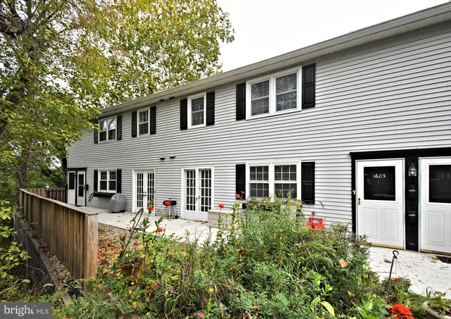 a front view of a house with wooden fence