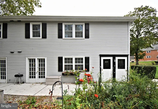 a view of a house with backyard and sitting area