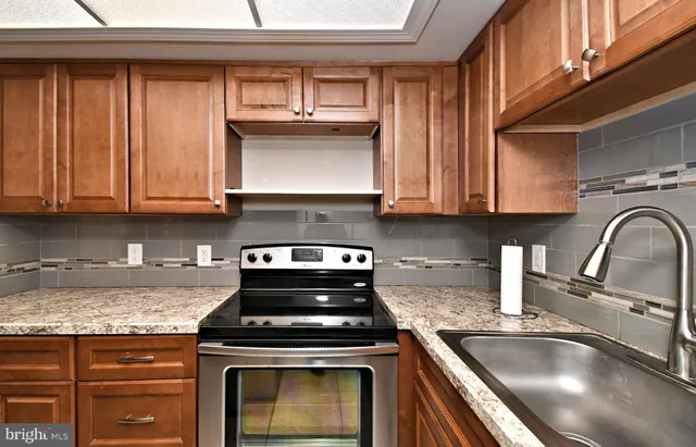 a kitchen with stainless steel appliances granite countertop a stove and a sink
