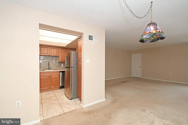 a view of a room with a dining table and chairs
