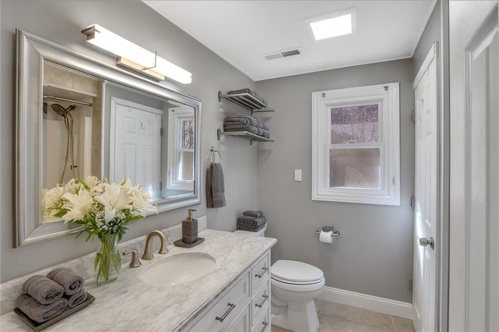 143 Northview Circle Beaver, PA 15009 - Photo 13 of 41 a bathroom with a granite countertop sink a toilet and a mirror