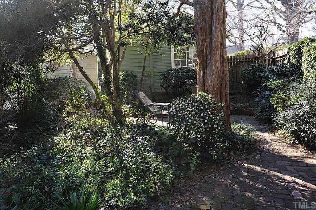 1707 Dare Street Raleigh, NC 27608 - Photo 12 of 12 A view of the backyard from the office nook. Notice the brick walkway and seperate studio/workshop.