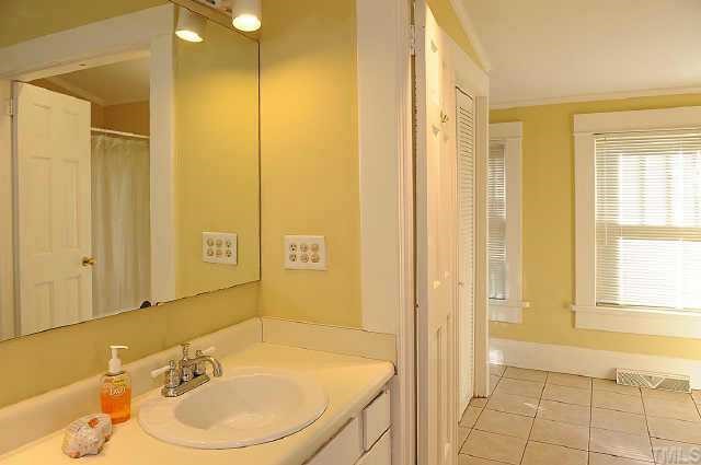 1707 Dare Street Raleigh, NC 27608 - Photo 9 of 12 A view of the seperate vanity/sink combo leading into the Master Bath & laundry area
