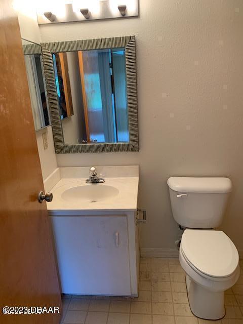 1601 Big Tree Road, Unit 108 Daytona Beach, FL 32119 - Photo 16 of 17 a bathroom with a sink a toilet and mirror