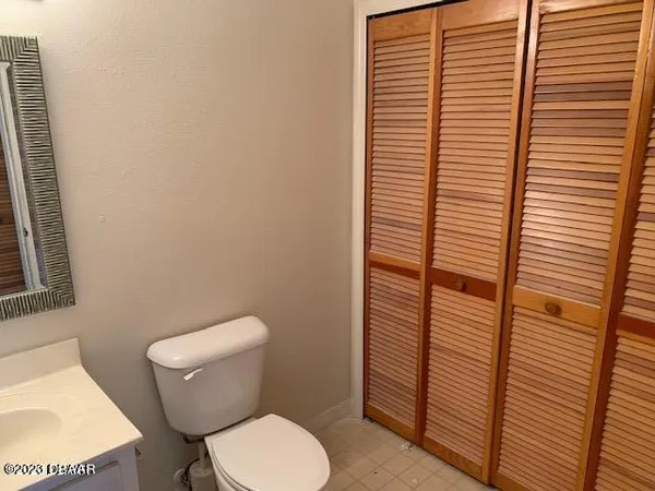 a white toilet sitting next to a small bathroom
