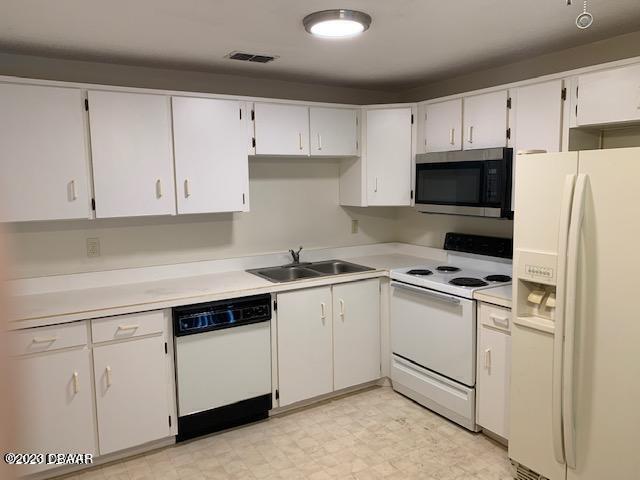 1601 Big Tree Road, Unit 108 Daytona Beach, FL 32119 - Photo 5 of 17 a kitchen with cabinets appliances a sink and a counter space