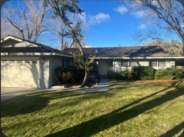 a view of a house with pool and sitting area
