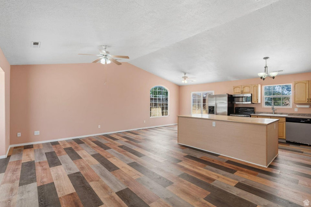 132 Rex Layne Drive Central, UT 84722 - Photo 4 of 39 Spacious open-concept interior featuring vaulted ceilings, wood-finish flooring, and a kitchen island