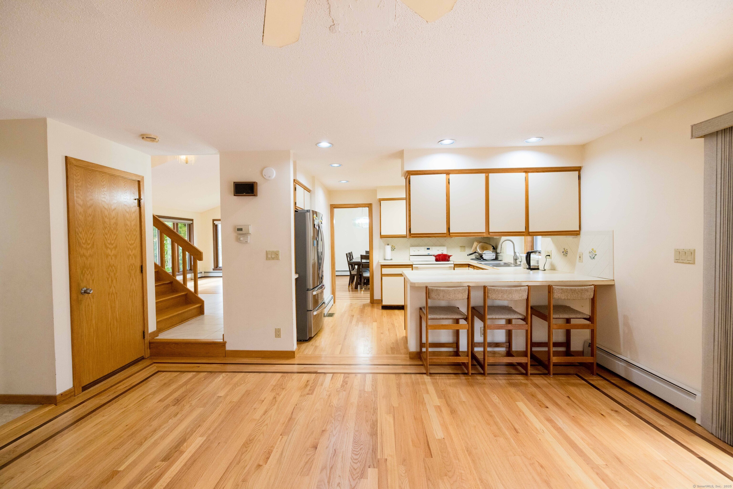18 Clifford Avenue Tolland, CT 06084 - Photo 11 of 40 a living room with stainless steel appliances kitchen island granite countertop furniture and a wooden floor