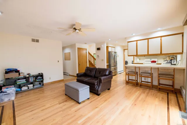 a living room with furniture and wooden floor