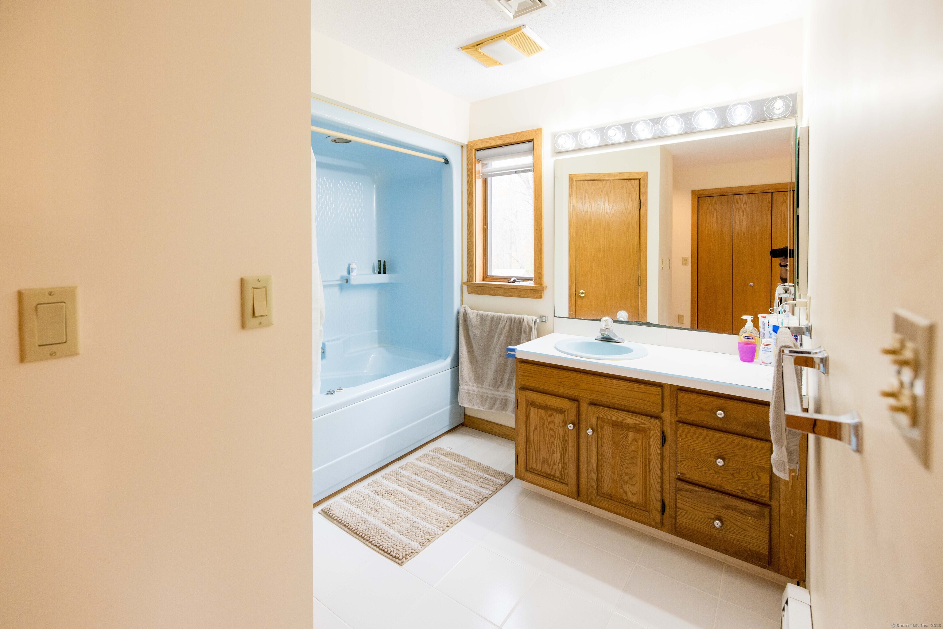 18 Clifford Avenue Tolland, CT 06084 - Photo 19 of 40 a spacious bathroom with a double vanity sink a large mirror and a bathtub