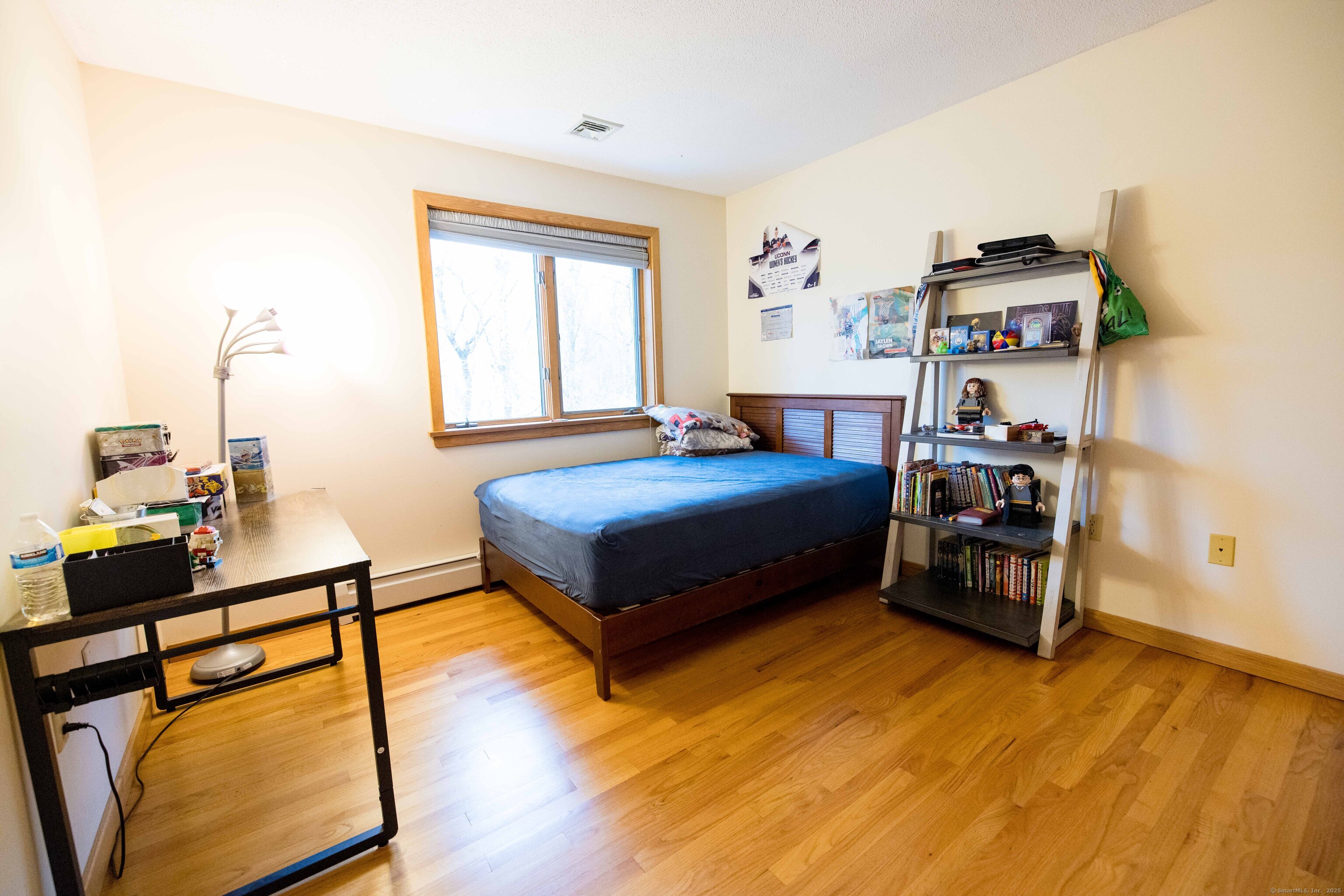 18 Clifford Avenue Tolland, CT 06084 - Photo 21 of 40 a bedroom with a bed and wooden floor