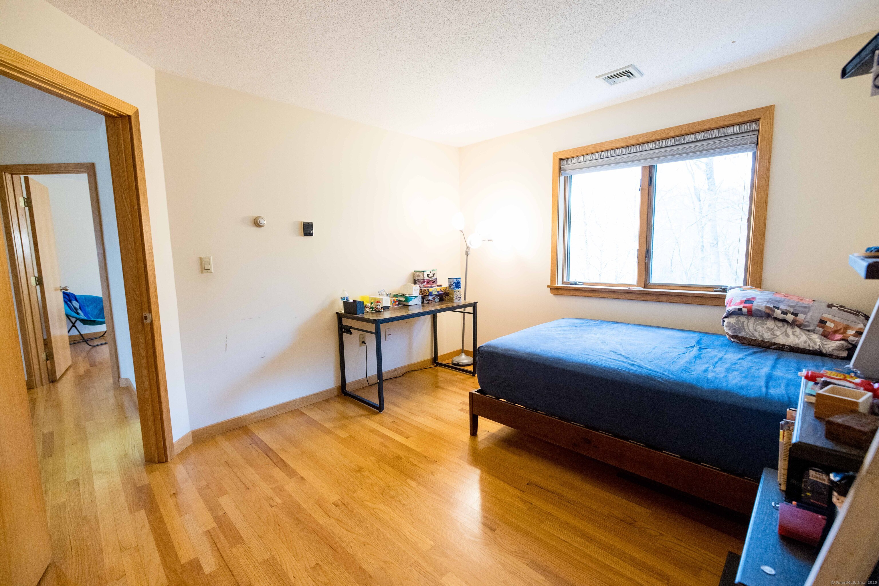 18 Clifford Avenue Tolland, CT 06084 - Photo 22 of 40 a bedroom with a bed and wooden floor