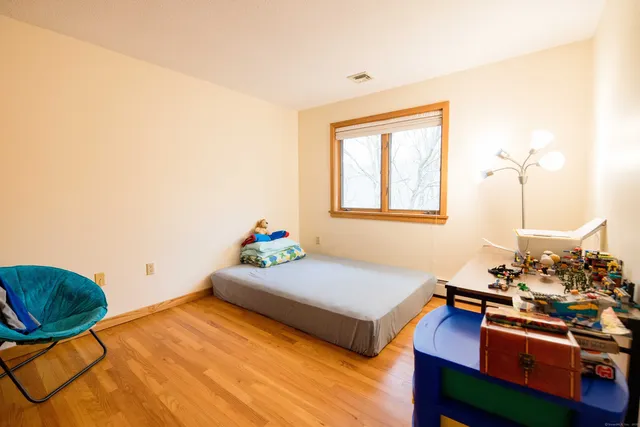 a bedroom with furniture and a window