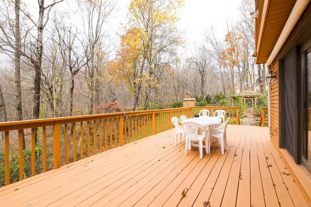 a view of a chairs and table on the wooden deck