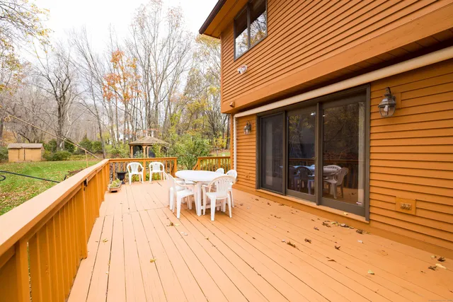a outdoor view with a sitting space and large trees