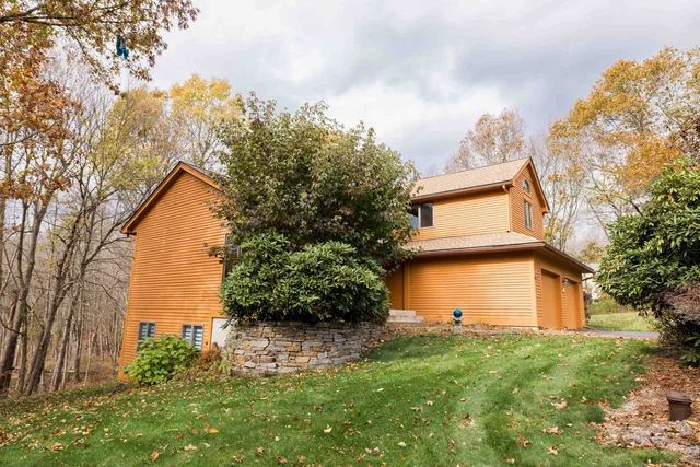 a view of a house with a backyard