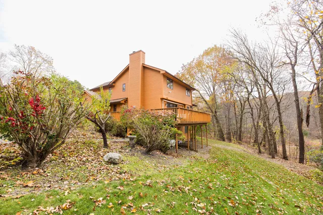 a backyard of a house with table and chairs