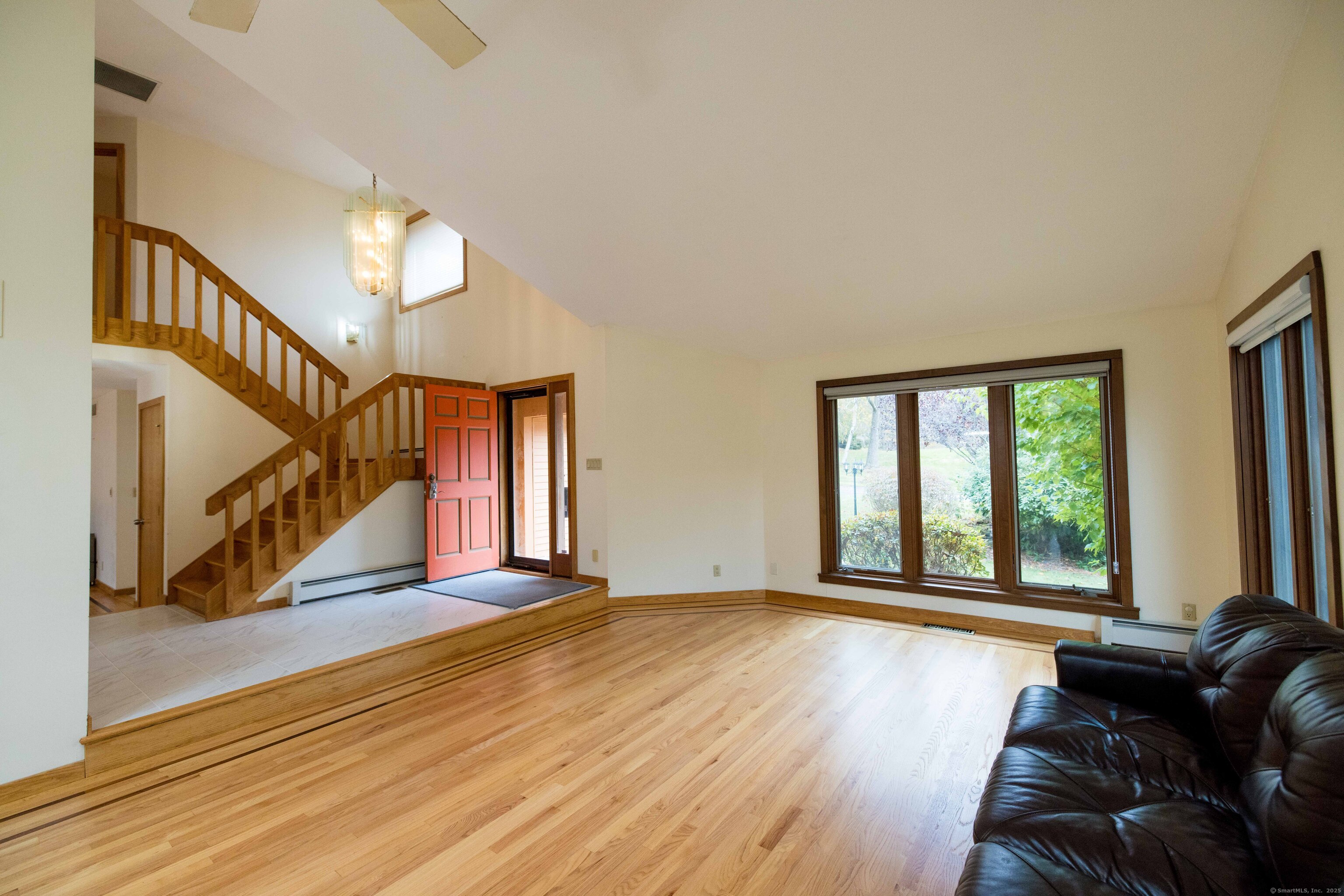 18 Clifford Avenue Tolland, CT 06084 - Photo 7 of 40 a view of a livingroom with wooden floor and stairs
